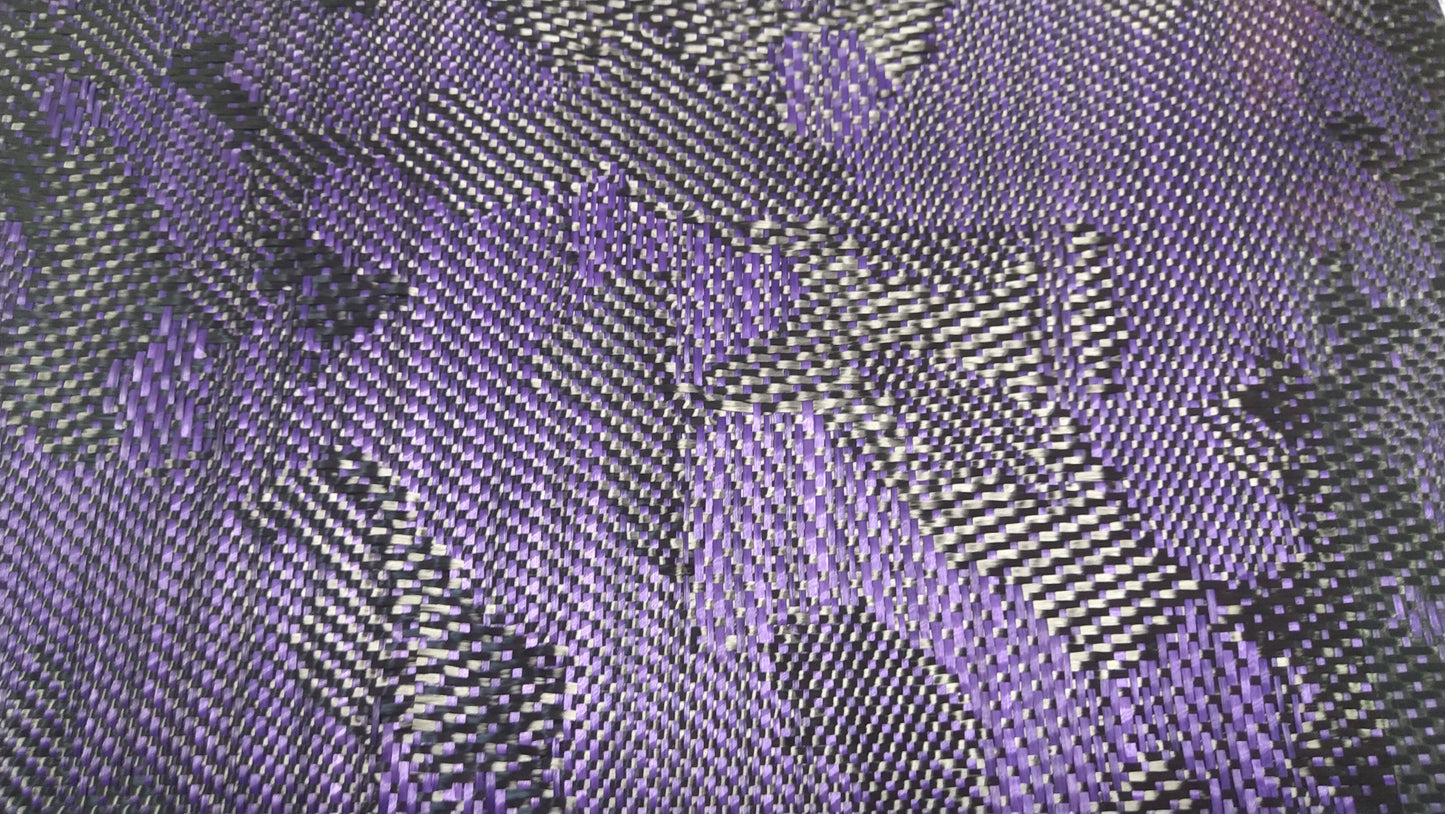 Patterned carbon fiber fabric showing alternating purple and black fibers.