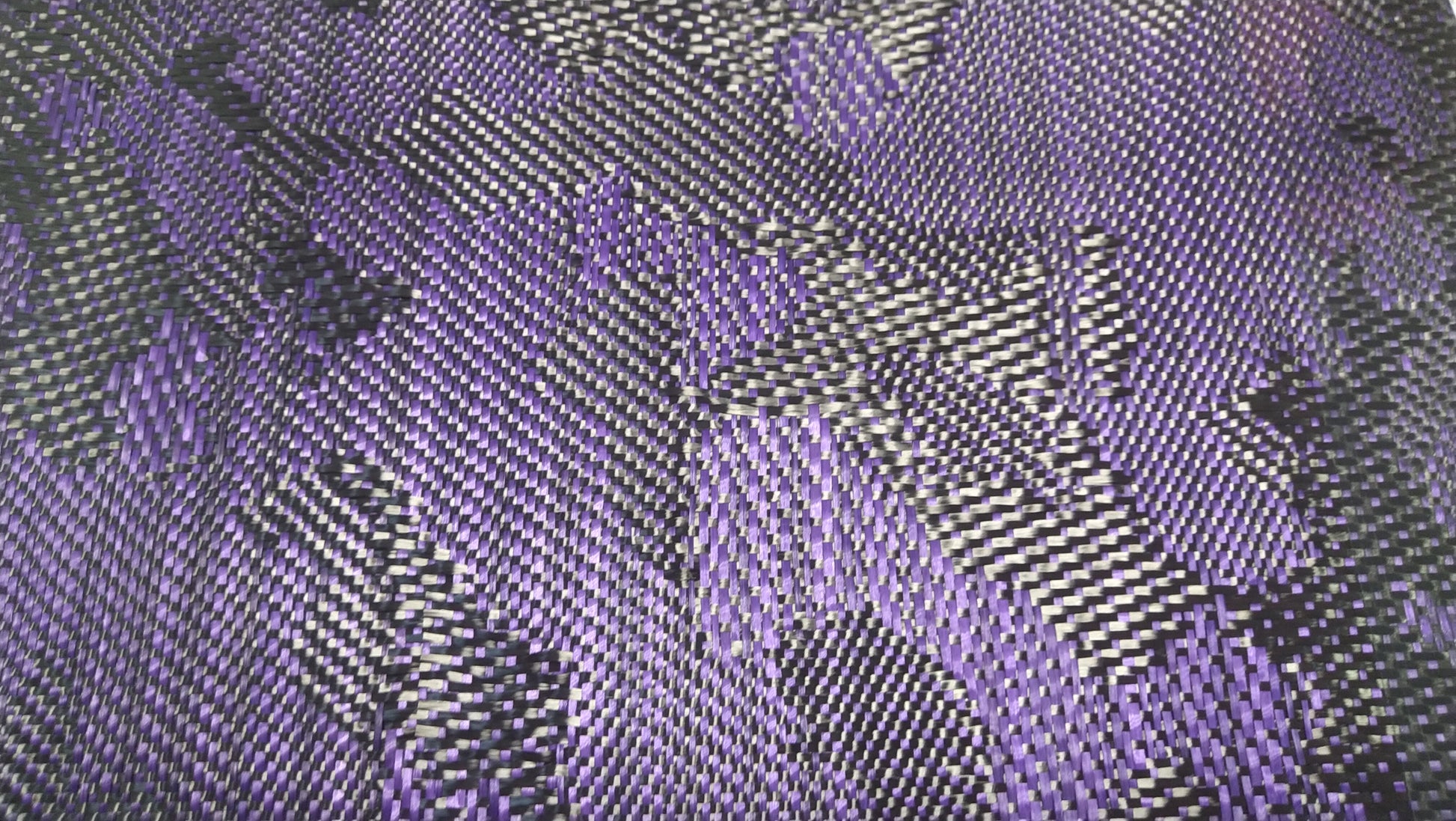 Patterned carbon fiber fabric showing alternating purple and black fibers.
